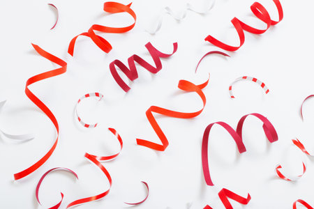 birthday background with red serpentine on white