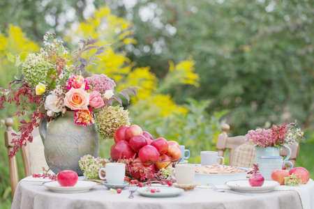 apple pie on laid table in garden on sunny dayの写真素材