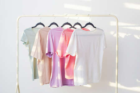 women's t-shirts on hanger on white backgroundの写真素材