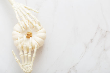 white halloween pumpkins with decor on marble backgroundの写真素材