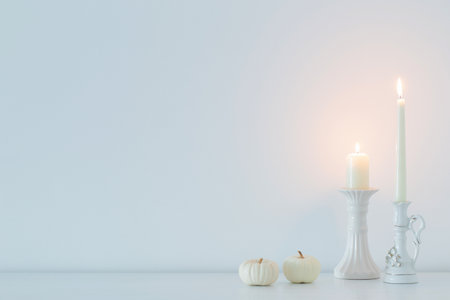 white burning candles on background white wallの写真素材
