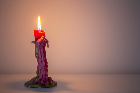 red burning candle in white interior