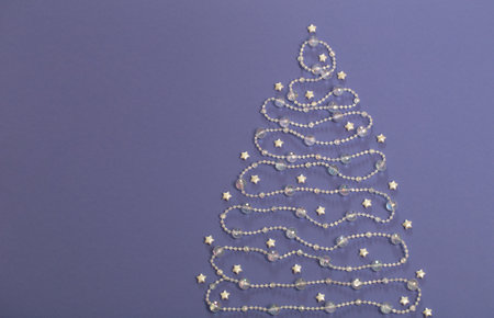 glass beads laid out in shape of Christmas tree on purple backgroundの写真素材