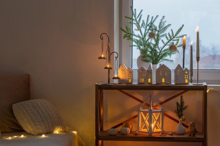 beautiful white room with christmas decor with burning candlesの写真素材