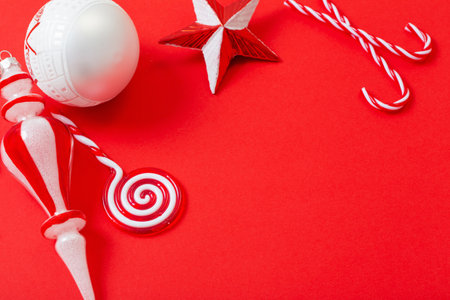 white and red christmas decorations on red backgroundの写真素材