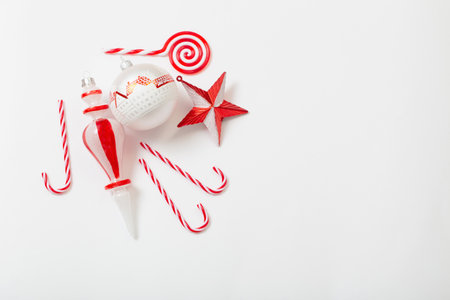 red and white christmas decorations on white backgroundの写真素材