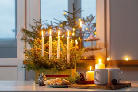 white cups with hot drink and christmas decorations at homeの写真素材