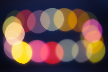 multi-colored bokeh of christmas lights on dark background