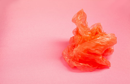 orange plastic bag on pink background