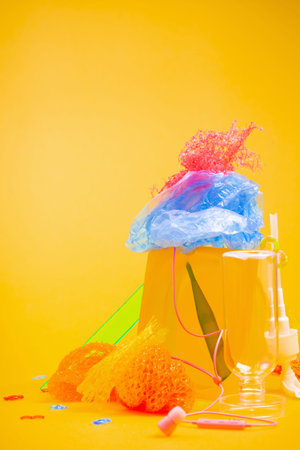 plastic trash on bright yellow backgroundの写真素材