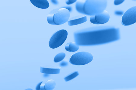 flying blue pills on blue background
