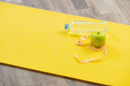 fitness mat on wooden floor, concept of health and sportの写真素材