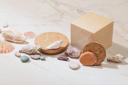 wooden podium with sea stones on marble backgroundの写真素材