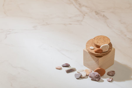 wooden podium with sea stones on marble background
