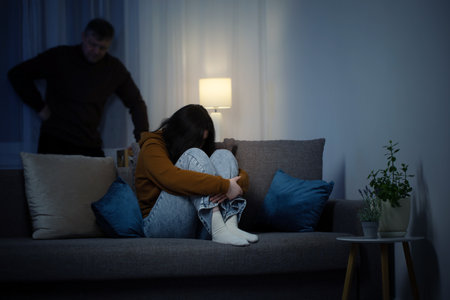 father and daughter teenager in living room in the evening, concept of problems in familyの写真素材