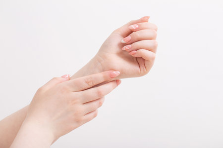 female hands with beautiful long nails with manicure with heart patternの写真素材