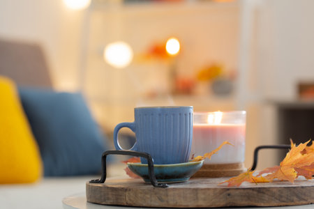cup of coffee in cozy interior with autumnal decorの写真素材