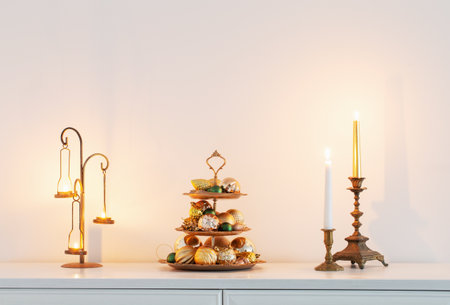 christmas golden decor with burning candles in white interiorの写真素材