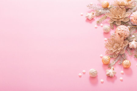 golden christmas decorations on pink backgroundの写真素材