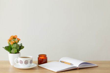 still life with house plant, notepad, pen and coffee cup in modern interiorの写真素材