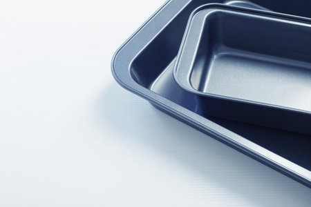 empty baking sheet on white wooden tableの写真素材