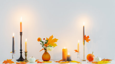 beautiful autumn home decor with burning candles in white interiorの写真素材