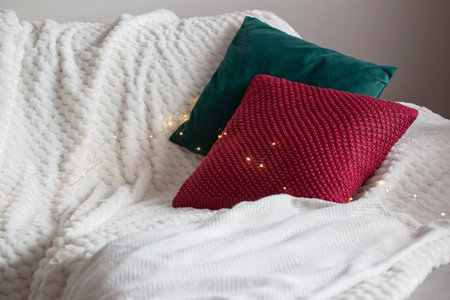 red and green pillow on sofa with lightsの写真素材