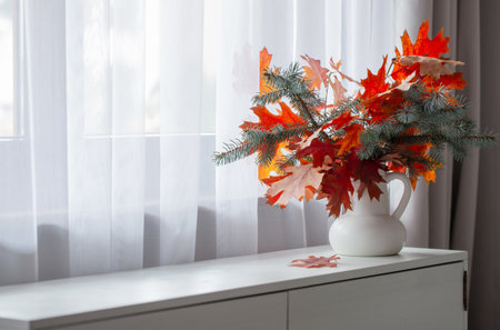 autumn bouquet in white vase on shelfの写真素材