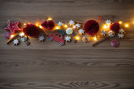 christmas decor and cookies with lights on wooden tableの写真素材