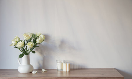 white roses in white jug in white interiorの写真素材