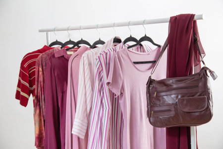 women's clothing in pink and burgundy trendy colors on a hangerの写真素材