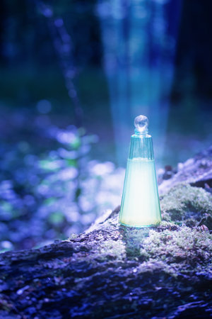 magican potion in glass bottle in summer forestの写真素材