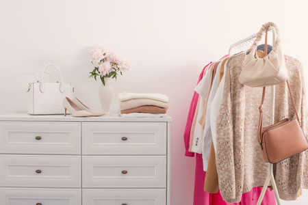 female clothes on hangers in white roomの写真素材