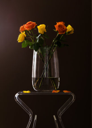 yellow roses in glass vaseの写真素材