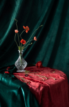 vintage still life with red poppies in a crystal decanter in green and red tonesの写真素材