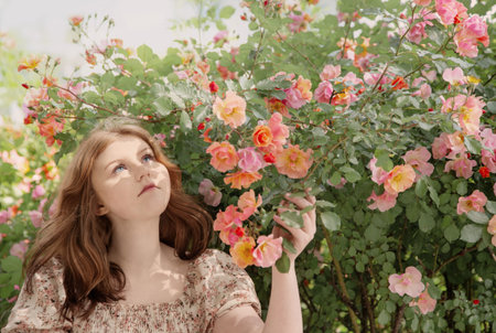young beautiful woman with roses in park