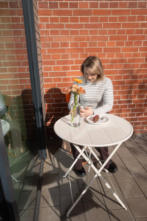 young woman with phone in cafe outdoorの写真素材