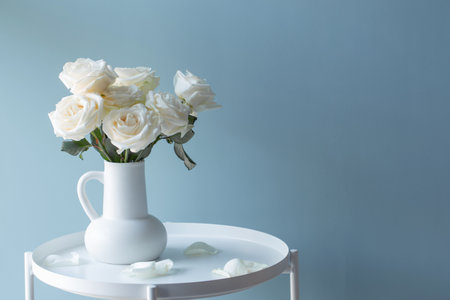 bouquet of white roses in white jug in modern interiorの写真素材