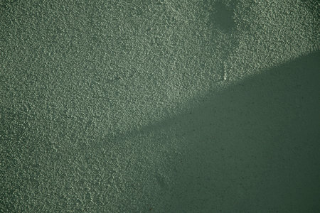 background of green old wall in sunlightの写真素材