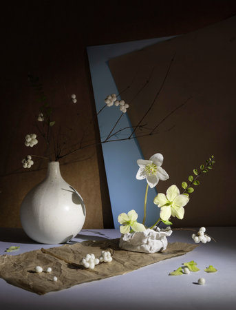 snowberry and hellebore flower on paper backgroundの写真素材