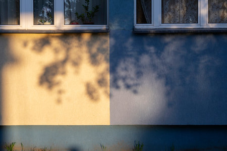 background of blue and yellow wall in sunlight