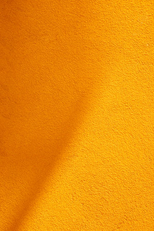 background of orange wall in sunlight with shadow