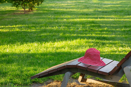 striped hat on a sun lounger in the park
