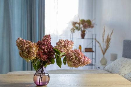 hydrangea in glass vase on wooden tableの写真素材