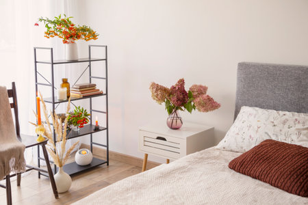 white cozy bedroom with flowers and candlesの写真素材