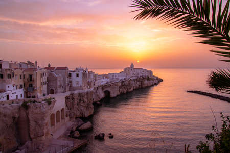 scenic sunset view over historic old town and church of San Francesco, Vieste, Gargano, Apulia, Italyのeditorial素材