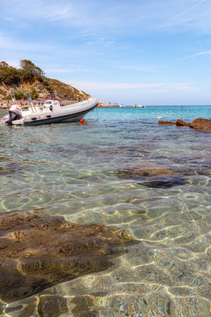 Sant Andrea, Elba Island, Italy - 06 June 2022 Motorboat in water at white sandy beach perfect for snorkeling and relaxation at Sant Andrea, Elba Island, Italyのeditorial素材