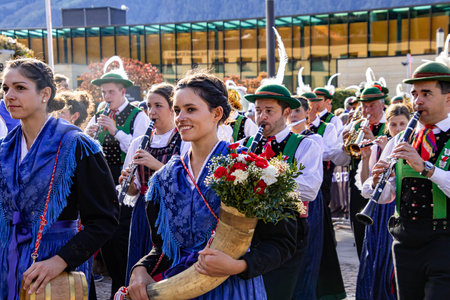 Meran, South Tyrol, Italy - 15 October 2023 Traditional parade of music bands at grape festivalのeditorial素材