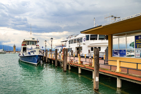 Desenzano, Lake Garda, Italy - 25 May 2024 Tour boats and ticket office at harbour of Desenzanoのeditorial素材