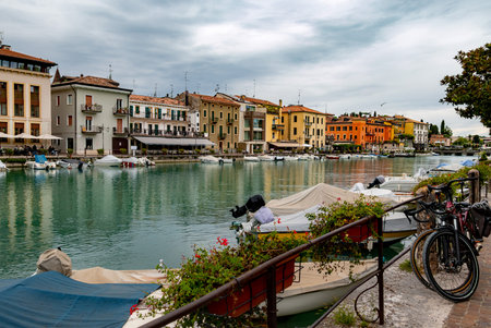 Colorful city view to canale di mezzo at Peschiera, Lago di Garda, Italyの写真素材